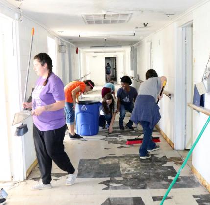 Local teens work to help clean up the former Stratford Nursing Home, which has been empty for over 12 years. The facility is being remodeled to host youth aging out of foster care, at-risk women and children, and widows in crisis.