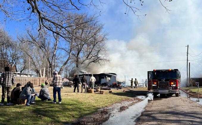 Pauls Valley firefighters work to put out a house fire on Madison Street Sunday morning. News Star photo by Suzanne Mackey